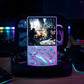 Handheld gaming console with screen displaying a scene, surrounded by colorful lights in a dark setting