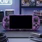 Purple handheld gaming console on a table with tools and cables