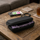 Fidgix Nova H™ console Black carrying case with a purple electronic device on a wooden table.