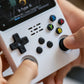 Hand holding a white handheld gaming console with colorful buttons, playing 'R-Type III'.